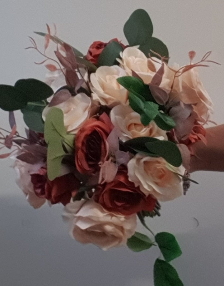 Terracotta Reverie bouquet close-up showing cream and terracotta roses with eucalyptus foliage