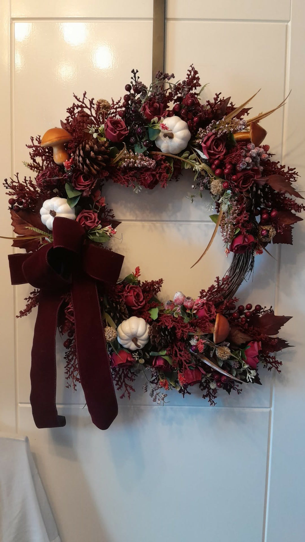 Burgundy Harvest Autumn Wreath close-up showing roses, pumpkins and velvet bow