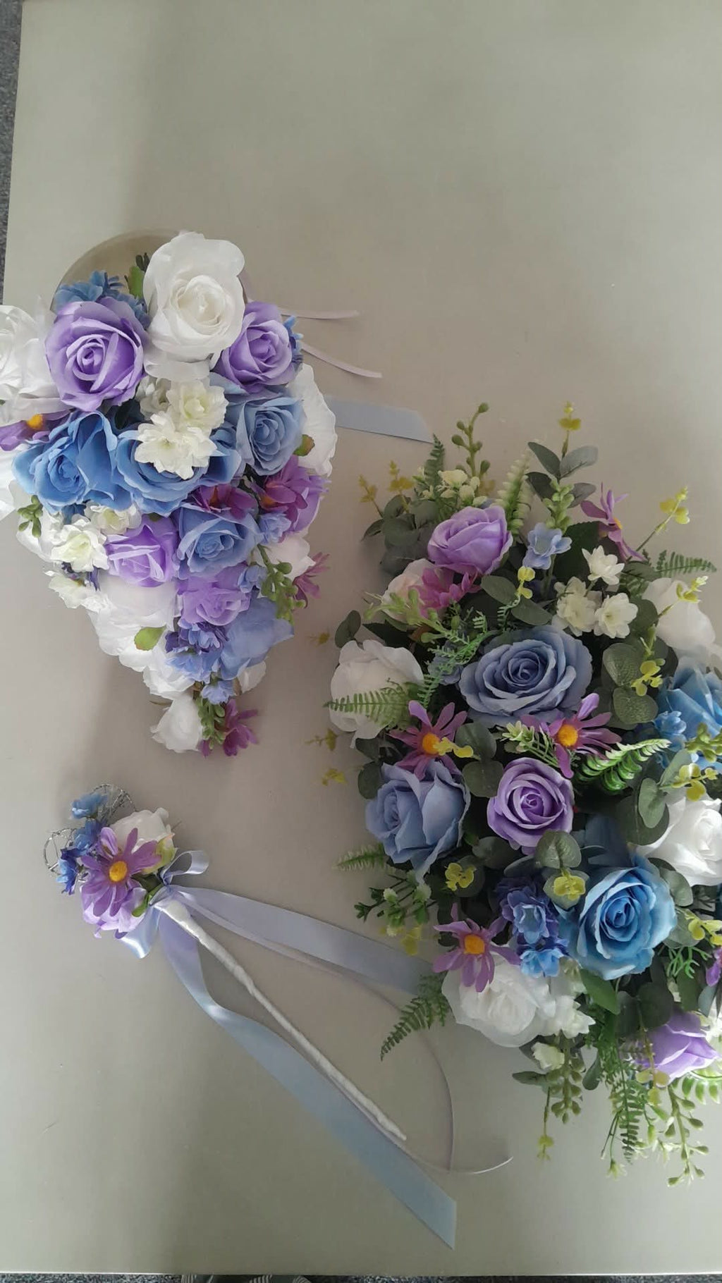 Thessaly wrist corsage with blue and purple artificial flowers and silver wire detail