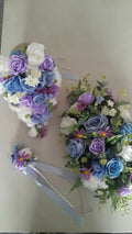 Thessaly wrist corsage with blue and purple artificial flowers and silver wire detail