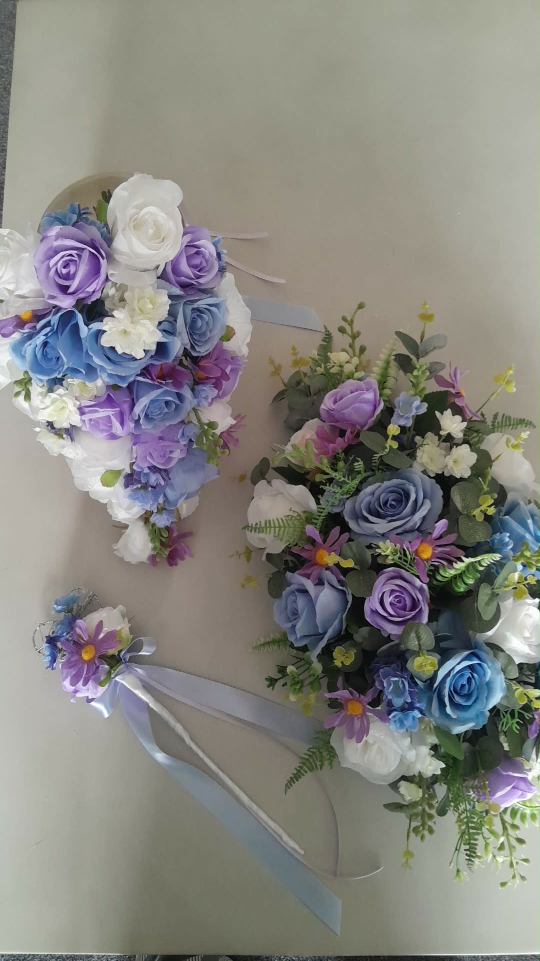 Thessaly wrist corsage with blue and purple artificial flowers and silver wire detail