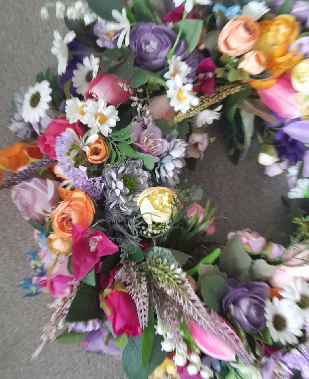 Rainbow Meadow Spring Wreath full view showing colourful artificial flower arrangement