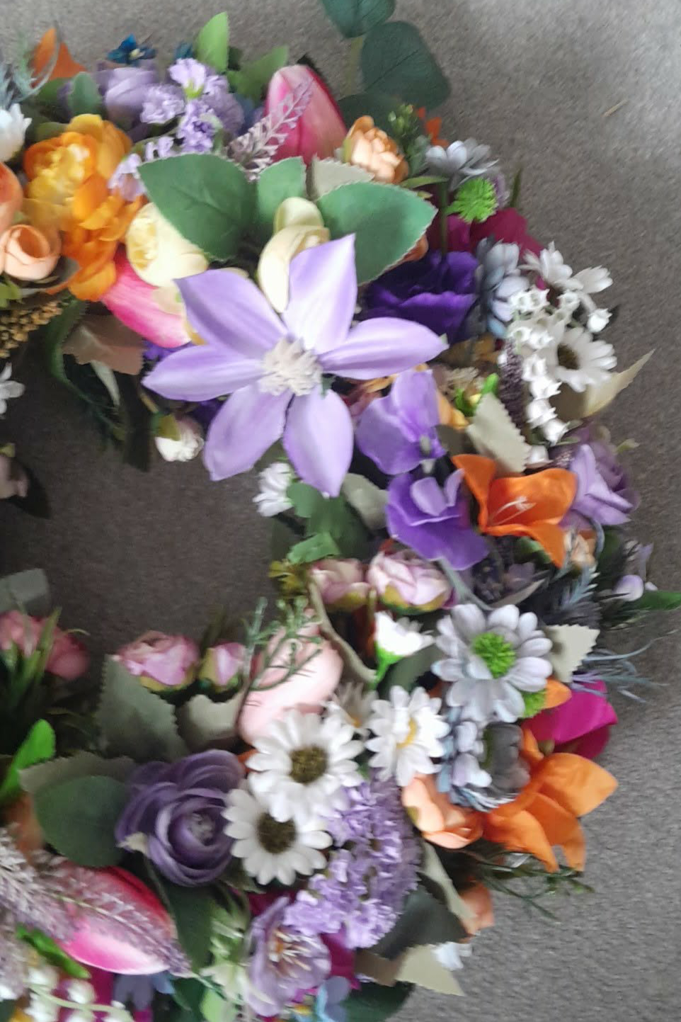 Rainbow Meadow Spring Wreath detail showing pink tulips, orange ranunculus and purple blooms