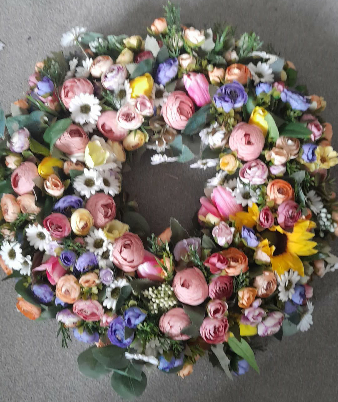 Spring summer mixed flower wreath full view — ranunculus, roses, daisies, sunflower and eucalyptus