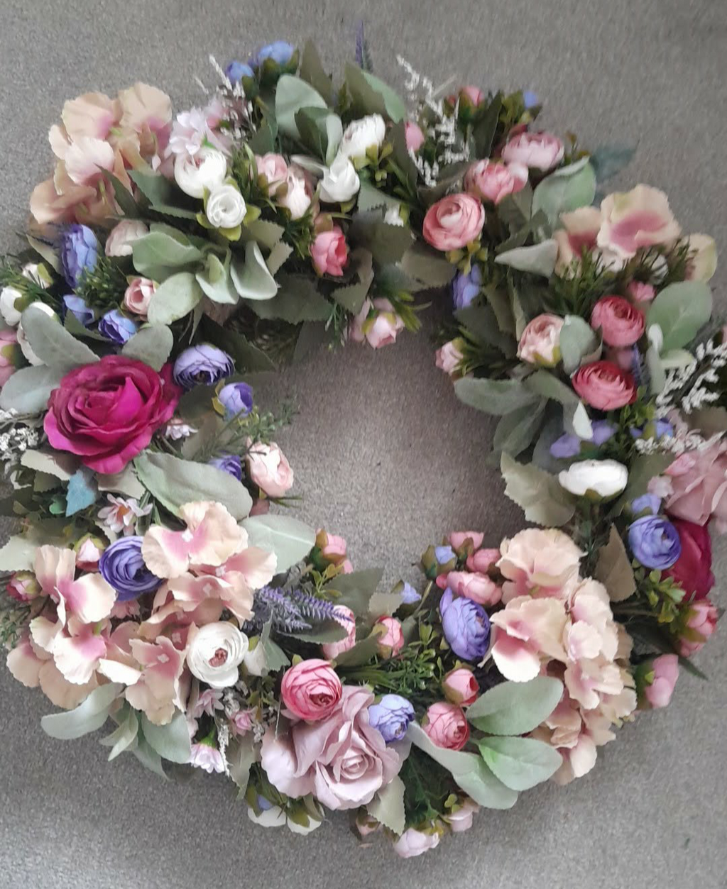 Pastel floral door wreath overhead view showing full circular arrangement