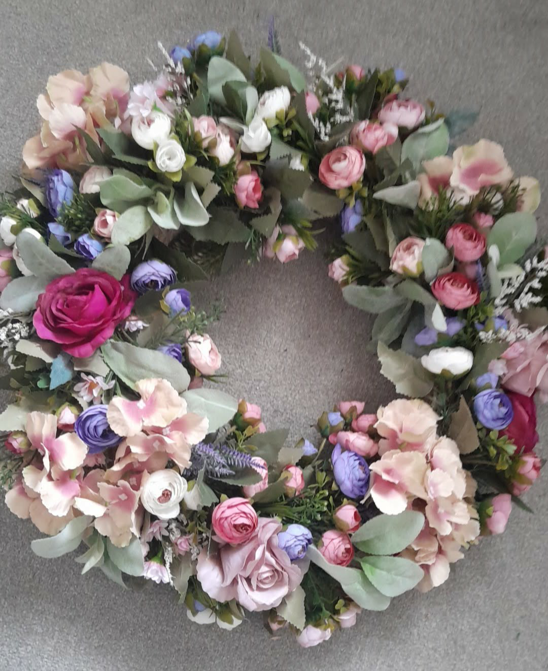Pastel floral door wreath overhead view showing full circular arrangement