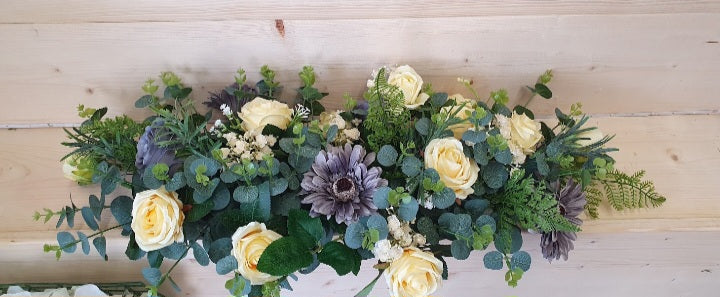 Saoirse top table arrangement - ivory roses, steel blue gerbera and eucalyptus foliage