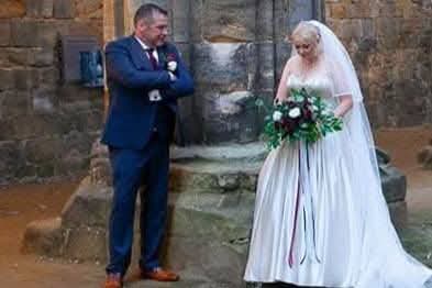 Araminta bridal bouquet black and white - bride descending stone steps holding lush cascading bouquet