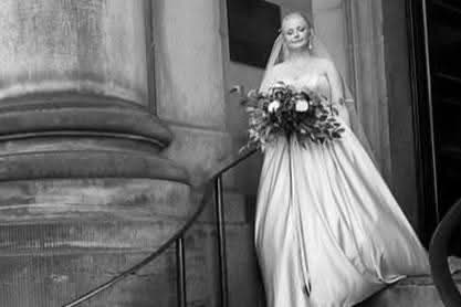 Araminta bouquet at ceremony - bride walking down the aisle holding deep burgundy and ivory bouquet