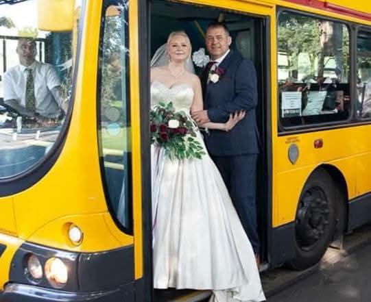 Araminta bouquet black and white - bride and groom walking hand in hand, trailing bouquet visible from behind