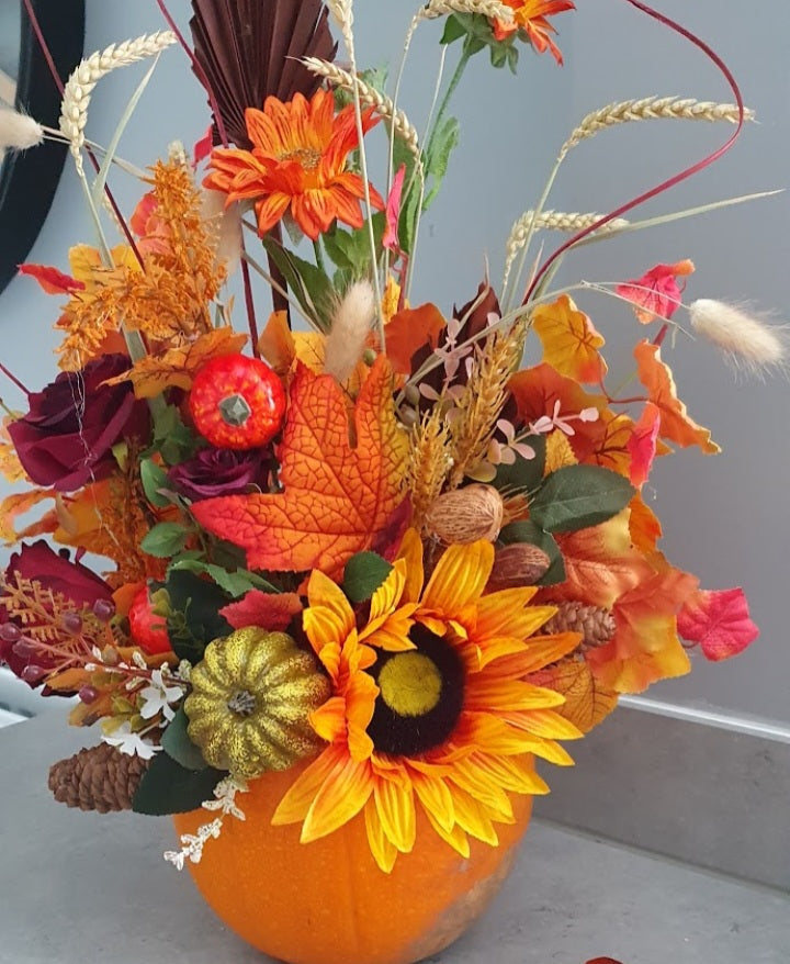 Hallow pumpkin autumn arrangement - sunflower, burgundy roses, orange gerbera, wheat, bunny tail grass and mini pumpkins in a real pumpkin vase