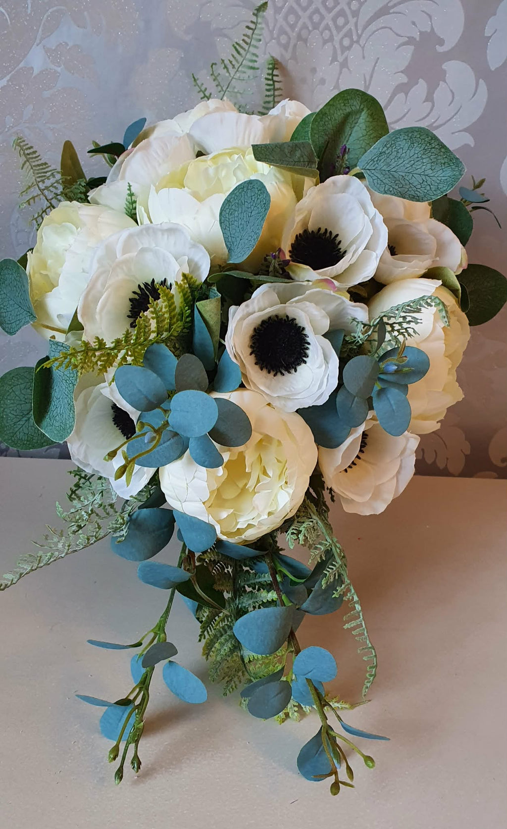 Thessaly cascading bridal bouquet — full view showing ivory peonies, white anemones and trailing eucalyptus fern