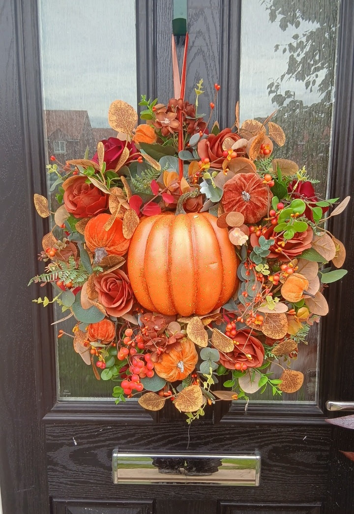 Autumn pumpkin wreath on front door