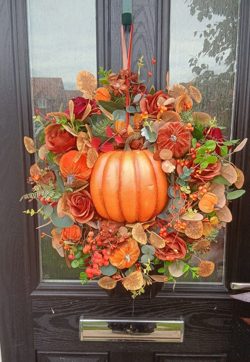 Autumn pumpkin wreath on front door