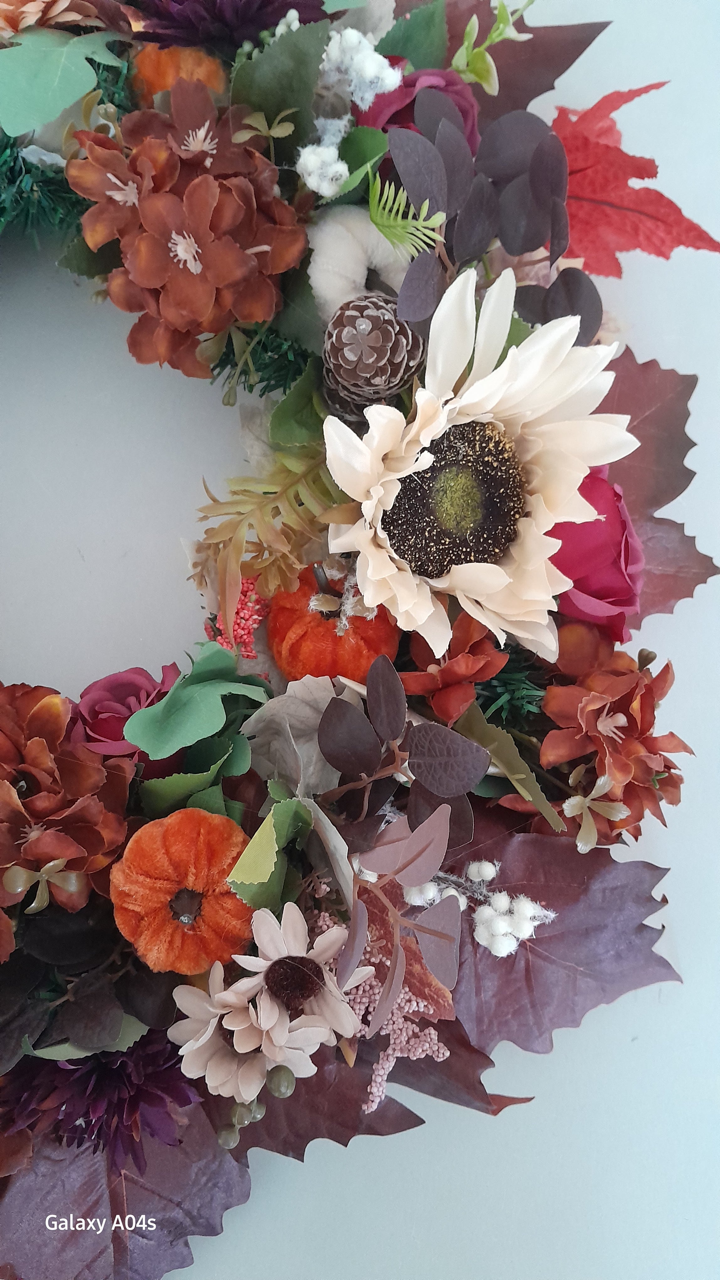 Full view of Sunflower & Pumpkin Autumn Wreath featuring golden sunflowers, orange pumpkins, burgundy and rust hydrangeas, roses, cotton stems and deep red maple leaves