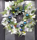 Blue and silver Christmas wreath on a black front door, full view
