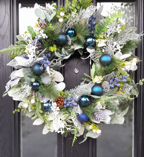 Blue and silver Christmas wreath on a black front door, full view
