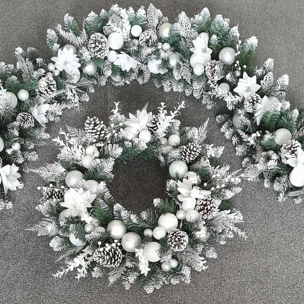 Detail of silver and white festive garland and matching door wreath