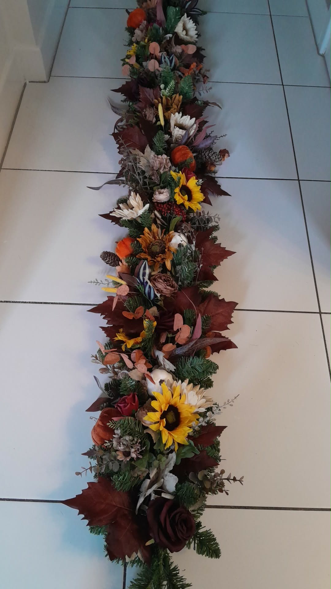 Close up of Luxury Autumn Door Garland featuring pumpkins, roses, berries and pine cones