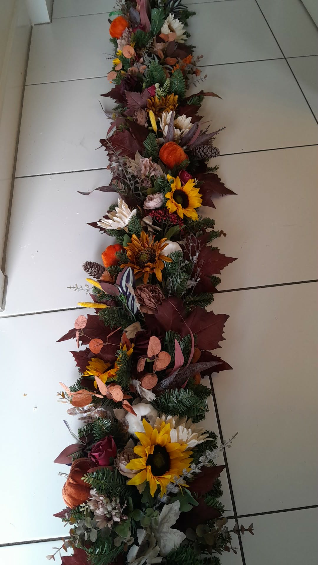 Luxury Autumn Door Garland laid flat showing full length with sunflowers, pine cones and autumn foliage