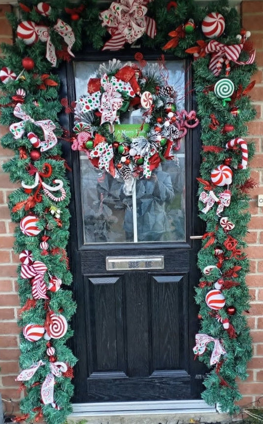 Christmas full door garland set with matching wreath close up detail showing candy cane decorations and festive ribbon bows