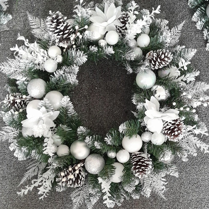 Silver and white 22-inch Christmas door wreath with white flowers and frosted pine cones
