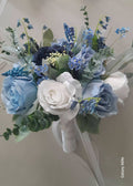 Arabella artificial wedding bouquet featuring blue roses, white roses, hydrangea, bluebells, muscari, sedum berry, noble leaf and spiral eucalyptus