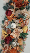 Autumn door frame garland detail with cream dahlias, white pumpkin, sunflowers and rich autumn foliage