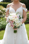 Bride holding pink and ivory bouquet