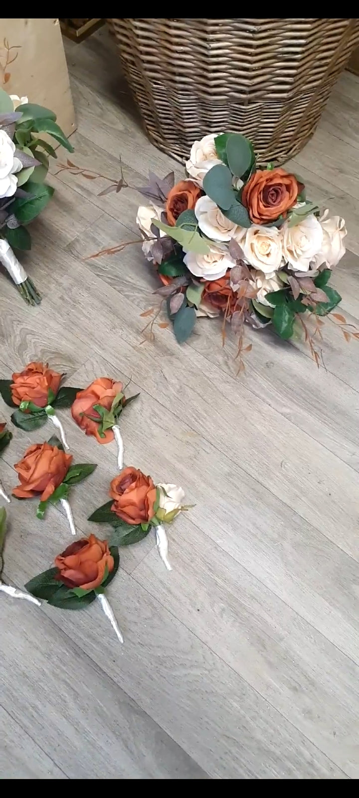 Terracotta Reverie bouquet laid against wicker basket showing full arrangement
