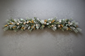 Frosted gold and white Christmas 6ft garland with eucalyptus, champagne baubles and white pearl berries on a grey background