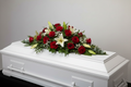 Red rose and white lily casket spray funeral tribute