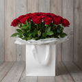 Red rose bouquet in white gift bag