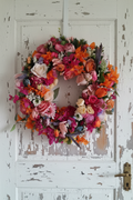 Vibrant Colourful Wreath on Rustic White Door